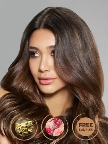Model showcasing healthy, shiny hair with Oro Therapy Gold mask, emphasizing free from SLS and parabens.